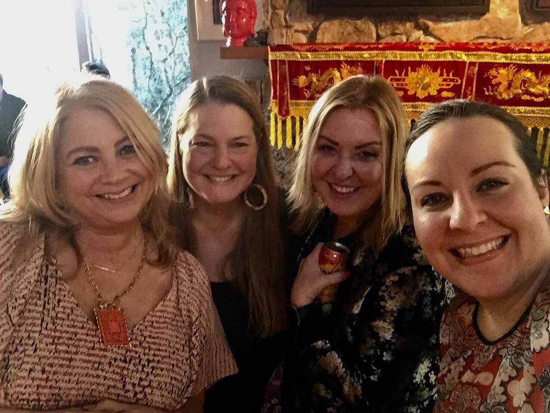 Lisa and friends smiling together for a group selfie